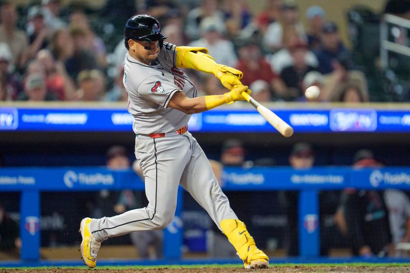Sep 12, 2025; Minneapolis, Minnesota, USA; Arizona Diamondbacks catcher Gabriel Moreno (14) hits a home run off Minnesota Twins pitcher Cole Sands (not shown) in the ninth inning at Target Field. Mandatory Credit: Matt Blewett-Imagn Images