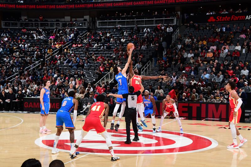 ATLANTA, GA - JANUARY 3: Clint Capela #15 of the Atlanta Hawks and Chet Holmgren #7 of the Oklahoma City Thunder jump for the tip off on January 3, 2024 at State Farm Arena in Atlanta, Georgia.  NOTE TO USER: User expressly acknowledges and agrees that, by downloading and/or using this Photograph, user is consenting to the terms and conditions of the Getty Images License Agreement. Mandatory Copyright Notice: Copyright 2024 NBAE (Photo by Scott Cunningham/NBAE via Getty Images)