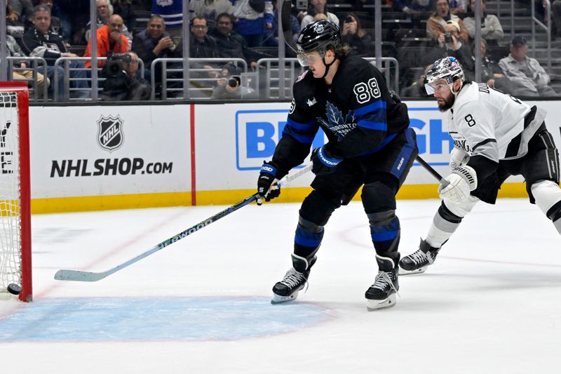 Jan 2, 2024; Los Angeles, California, USA; Toronto Maple Leafs right wing William Nylander (88) gets past Los Angeles Kings defenseman Drew Doughty (8) to score on an empty net in the third period at Crypto.com Arena. Mandatory Credit: Jayne Kamin-Oncea-USA TODAY Sports
