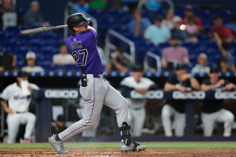 Jun 3, 2025; Miami, Florida, USA; Colorado Rockies left fielder Jordan Beck (27) hits a single against the Miami Marlins during the third inning at loanDepot Park. Mandatory Credit: Sam Navarro-Imagn Images
