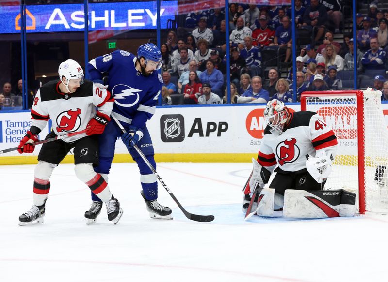 Jan 27, 2024; Tampa, Florida, USA; Tampa Bay Lightning left wing Nicholas Paul (20) shoots on New Jersey Devils goaltender Vitek Vanecek (41) as New Jersey Devils defenseman Colin Miller (24) defends during the third period at Amalie Arena. Mandatory Credit: Kim Klement Neitzel-USA TODAY Sports