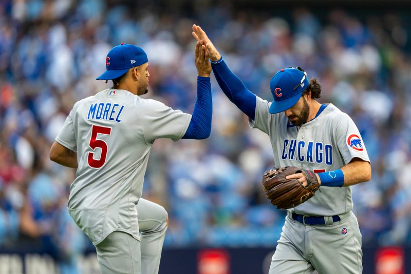 Aug 12, 2023; Toronto, Ontario, CAN; Chicago Cubs second baseman Christopher Morel (5) celebrates with teammate shortstop Dansby Swanson (7) after defeating the Toronto Blue Jays at Rogers Centre. Mandatory Credit: Kevin Sousa-USA TODAY Sports