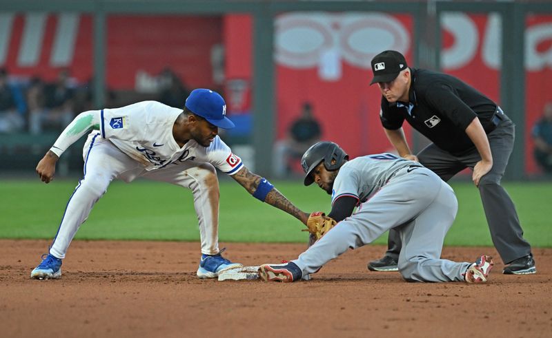 Jun 25, 2024; Kansas City, Missouri, USA; Miami Marlins second baseman Otto Lopez (61) steals second base against Kansas City Royals second baseman Maikel Garcia (11) in the fifth inning against the at Kauffman Stadium. Mandatory Credit: Peter Aiken-USA TODAY Sports