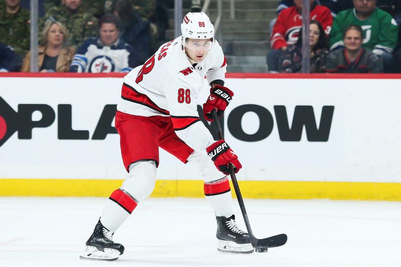 Dec 4, 2023; Winnipeg, Manitoba, CAN;   Carolina Hurricanes forward Martin Necas (88) skates into the Winnipeg Jets zone during the first period at Canada Life Centre. Mandatory Credit: Terrence Lee-USA TODAY Sports