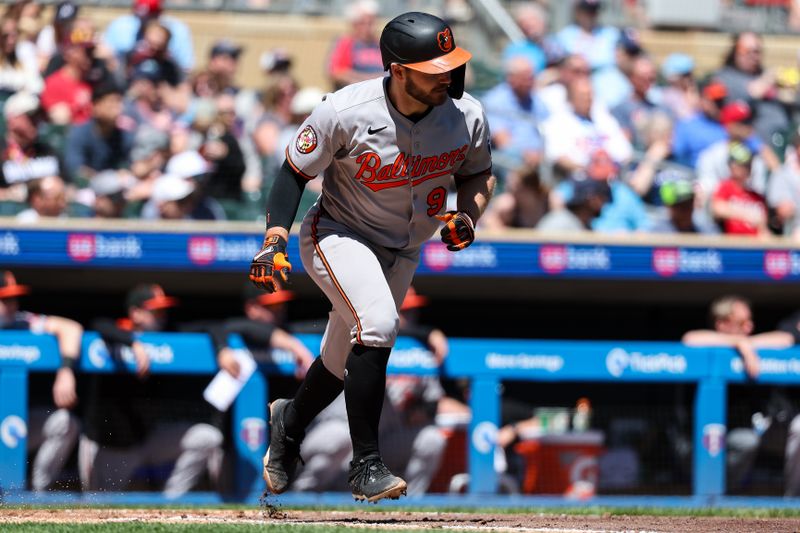 May 8, 2025; Minneapolis, Minnesota, USA; Baltimore Orioles catcher Maverick Handley (98) hits his first career base hit against the Minnesota Twins during the fourth inning at Target Field. Mandatory Credit: Matt Krohn-Imagn Images
