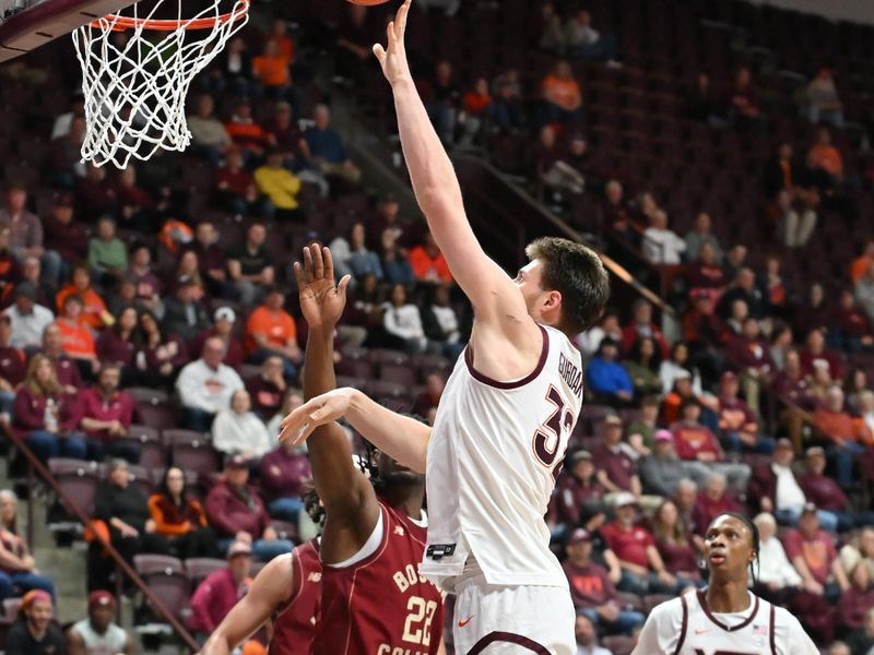 Mar 3, 2026; Blacksburg, Virginia, USA;  Virginia Tech Hokies center Christian Gurdak (32) shoots a shot defended by Boston College Eagles forward Jayden Hastings (22) during the first half at Cassell Coliseum. Mandatory Credit: Brian Bishop-Imagn Images