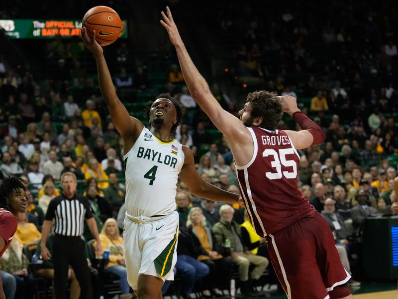 Feb 8, 2023; Waco, Texas, USA;  Baylor Bears guard LJ Cryer (4) scores a layup against Oklahoma Sooners forward Tanner Groves (35) during the first half at Ferrell Center. Mandatory Credit: Chris Jones-USA TODAY Sports