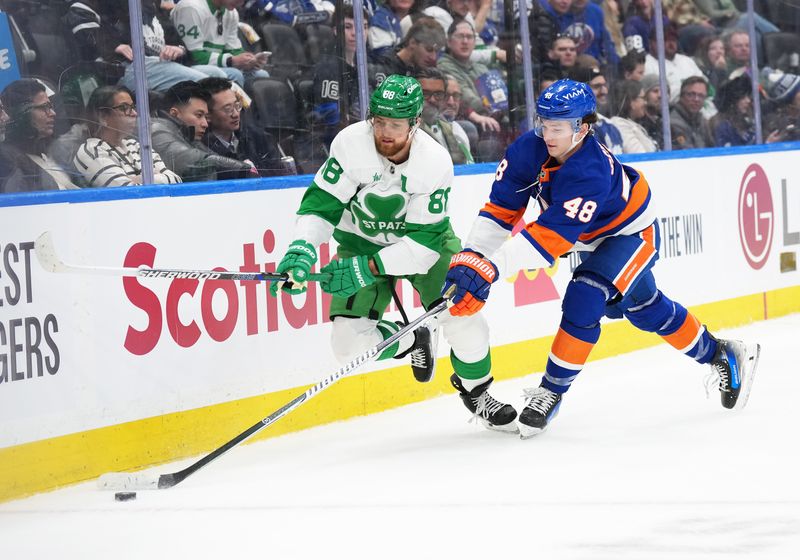 Mar 17, 2026; Toronto, Ontario, CAN; Toronto Maple Leafs right wing William Nylander (88) battles for the puck with New York Islanders defenseman Matthew Schaefer (48) during the third period at Scotiabank Arena. Mandatory Credit: Nick Turchiaro-Imagn Images