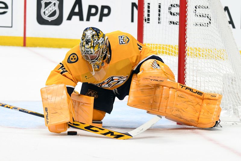 Feb 10, 2024; Nashville, Tennessee, USA; Nashville Predators goaltender Juuse Saros (74) makes a save in overtime against the Arizona Coyotes at Bridgestone Arena. Mandatory Credit: Christopher Hanewinckel-USA TODAY Sports