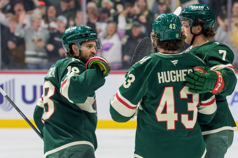 Dec 23, 2025; Saint Paul, Minnesota, USA; Minnesota Wild defenseman Brock Faber (7) is congratulated by defenseman Quinn Hughes (43) and center Vinnie Hinostroza (18) after scoring on the Nashville Predators in the first period at Grand Casino Arena. Mandatory Credit: Matt Blewett-Imagn Images