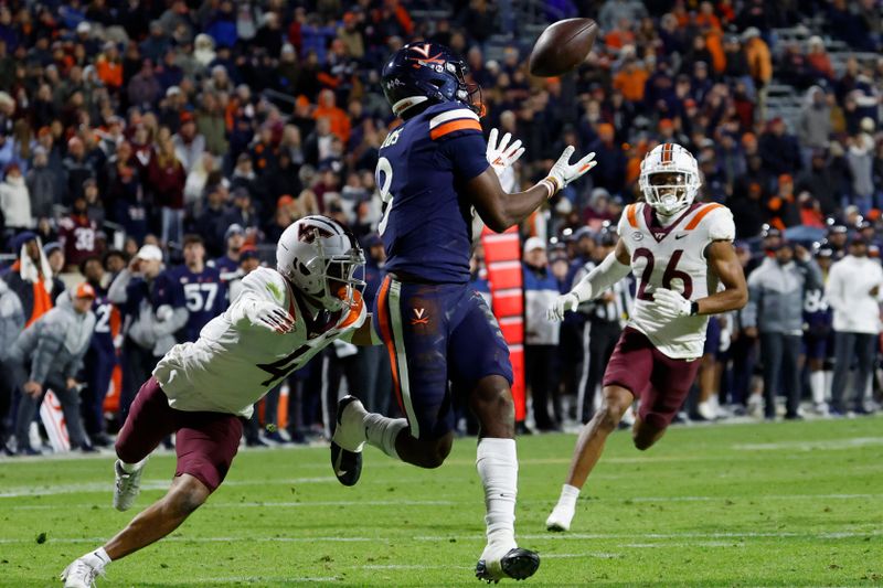 Nov 25, 2023; Charlottesville, Virginia, USA; Virginia Cavaliers wide receiver Malachi Fields (8) catches a touchdown pass as Virginia Tech Hokies cornerback Mansoor Delane (4) defends during the third quarter at Scott Stadium. Mandatory Credit: Geoff Burke-USA TODAY Sports