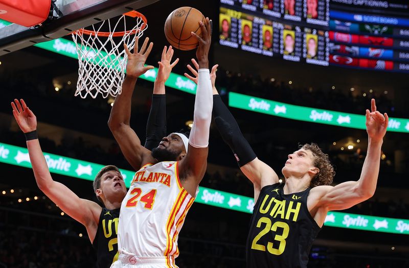 ATLANTA, GEORGIA - FEBRUARY 27:  Bruno Fernando #24 of the Atlanta Hawks attacks the basket against Walker Kessler #24 and Lauri Markkanen #23 of the Utah Jazz during the first quarter at State Farm Arena on February 27, 2024 in Atlanta, Georgia.  NOTE TO USER: User expressly acknowledges and agrees that, by downloading and/or using this photograph, user is consenting to the terms and conditions of the Getty Images License Agreement.  (Photo by Kevin C. Cox/Getty Images)