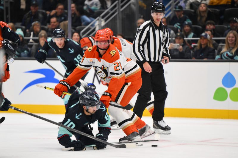 Nov 27, 2024; Seattle, Washington, USA; Anaheim Ducks center Isac Lundestrom (21) checks Seattle Kraken center Matty Beniers (10) during the first period at Climate Pledge Arena. Mandatory Credit: Steven Bisig-Imagn Images