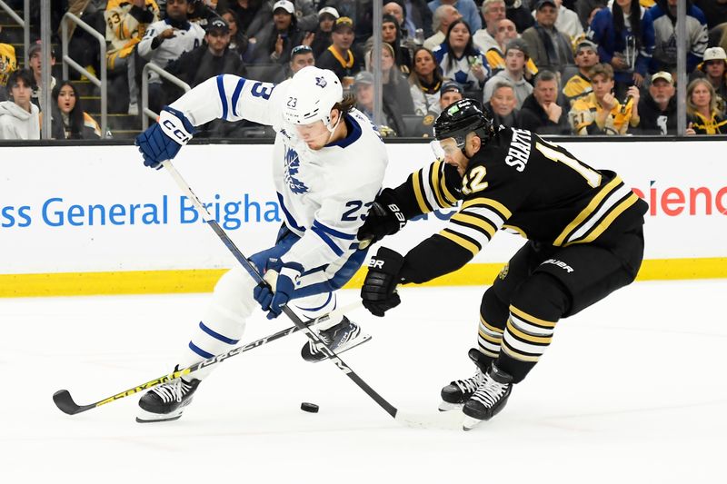 May 4, 2024; Boston, Massachusetts, USA; Boston Bruins defenseman Kevin Shattenkirk (12) defends against Toronto Maple Leafs left wing Matthew Knies (23) during the second period in game seven of the first round of the 2024 Stanley Cup Playoffs at TD Garden. Mandatory Credit: Bob DeChiara-USA TODAY Sports