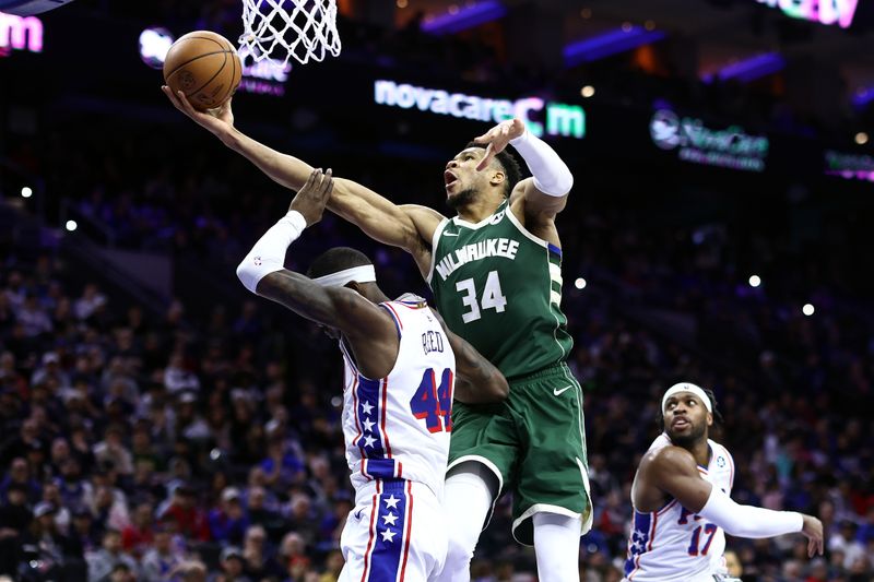 PHILADELPHIA, PENNSYLVANIA - FEBRUARY 25: Giannis Antetokounmpo #34 of the Milwaukee Bucks shoots a lay up past Paul Reed #44 of the Philadelphia 76ers during the third quarter at the Wells Fargo Center on February 25, 2024 in Philadelphia, Pennsylvania. (Photo by Tim Nwachukwu/Getty Images)