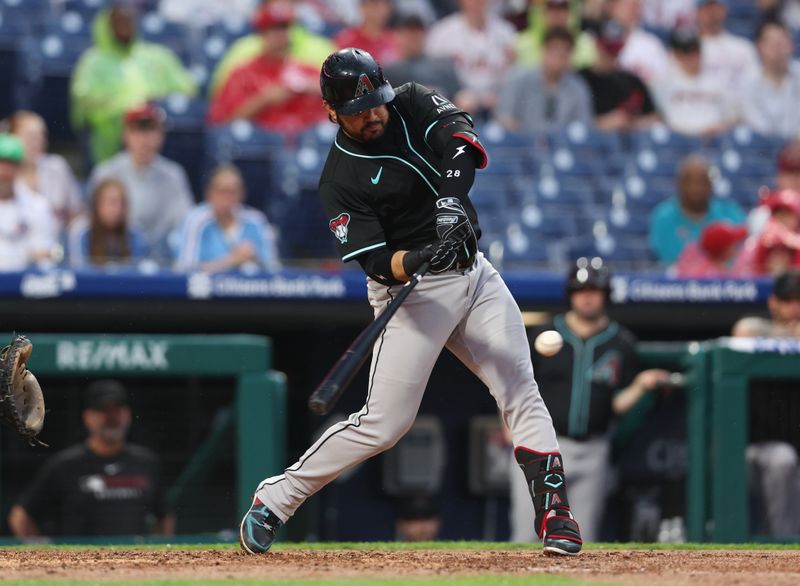 May 3, 2025; Philadelphia, Pennsylvania, USA; Arizona Diamondbacks third base Eugenio Suarez (28) hits a single during the fourth inning against the Philadelphia Phillies at Citizens Bank Park. Mandatory Credit: Bill Streicher-Imagn Images
