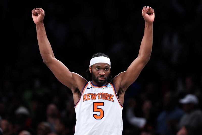 NEW YORK, NEW YORK - JANUARY 23: Precious Achiuwa #5 of the New York Knicks reacts during the fourth quarter of the game against the Brooklyn Nets at Barclays Center on January 23, 2024 in New York City.  NOTE TO USER: User expressly acknowledges and agrees that, by downloading and or using this photograph, User is consenting to the terms and conditions of the Getty Images License Agreement. (Photo by Dustin Satloff/Getty Images)