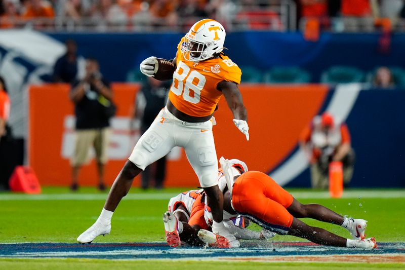 Dec 30, 2022; Miami Gardens, FL, USA; Tennessee Volunteers tight end Princeton Fant (88) eludes a tackle by Clemson Tigers safety Jalyn Phillips (25) and cornerback Toriano Pride Jr. (23) during the first half of the 2022 Orange Bowl at Hard Rock Stadium. Mandatory Credit: Rich Storry-USA TODAY Sports