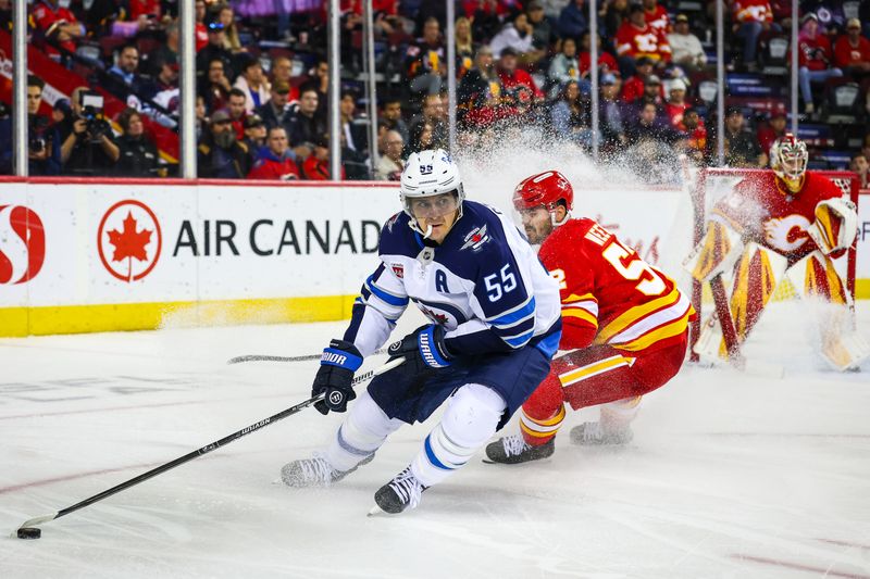 Oct 3, 2025; Calgary, Alberta, CAN; Winnipeg Jets center Mark Scheifele (55) controls the puck against Calgary Flames defenseman MacKenzie Weegar (52) during the third period at Scotiabank Saddledome. Mandatory Credit: Sergei Belski-Imagn Images