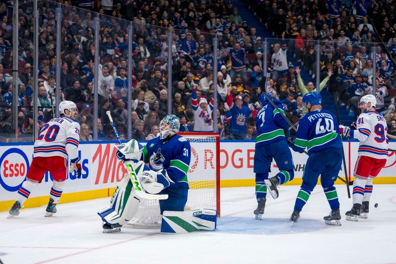 Nov 19, 2024; Vancouver, British Columbia, CAN; Vancouver Canucks defenseman Carson Soucy (7) and forward Elias Pettersson (40) and goalie Arturs Silovs (31) and New York Rangers forward Reilly Smith (91) react as forward Chris Kreider (20) celebrates his goal during the third period at Rogers Arena. Mandatory Credit: Bob Frid-Imagn Images