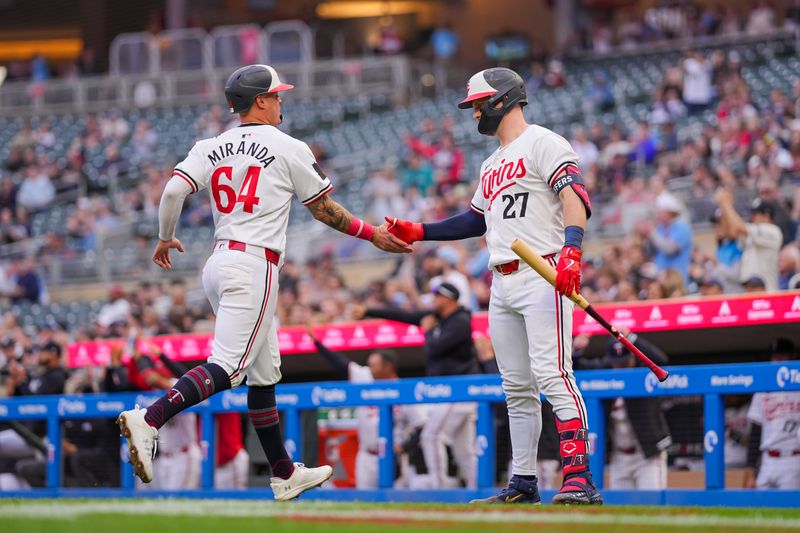 May 7, 2024; Minneapolis, Minnesota, USA; Minnesota Twins third baseman Jose Miranda (64) celebrates his run with catcher Ryan Jeffers (27) against the Seattle Mariners in the third inning at Target Field. Mandatory Credit: Brad Rempel-USA TODAY Sports