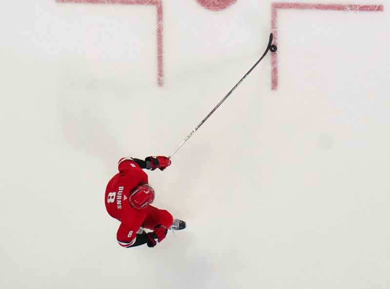 Dec 23, 2023; Raleigh, North Carolina, USA; Carolina Hurricanes defenseman Brent Burns (8) skates with the puck against the New York Islanders during the first period at PNC Arena. Mandatory Credit: James Guillory-USA TODAY Sports