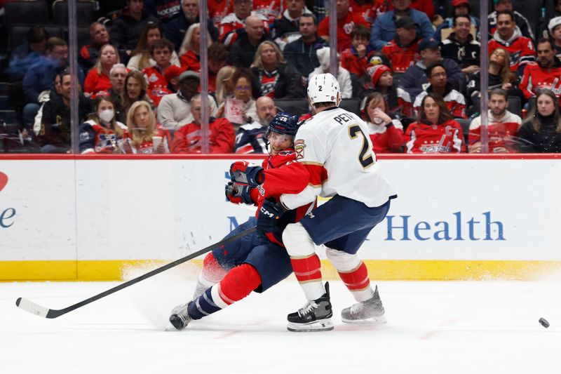 Jan 17, 2026; Washington, District of Columbia, USA; Washington Capitals center Nic Dowd (26) and Florida Panthers defenseman Jeff Petry (2) battle for the puck during the first period at Capital One Arena. Mandatory Credit: Geoff Burke-Imagn Images
