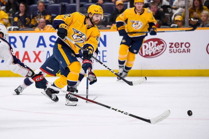 Apr 13, 2024; Nashville, Tennessee, USA; Nashville Predators center Tommy Novak (82) takes a shot on goal against the Columbus Blue Jackets during the third period at Bridgestone Arena. Mandatory Credit: Steve Roberts-USA TODAY Sports