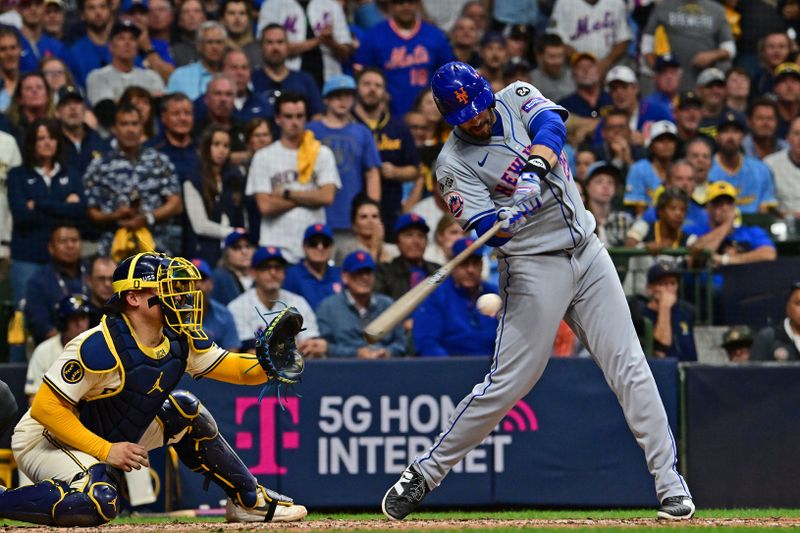 Oct 1, 2024; Milwaukee, Wisconsin, USA; New York Mets designated hitter J.D. Martinez (28) hits a two run single against the Milwaukee Brewers during the fifth inning in game one of the Wildcard round for the 2024 MLB Playoffs at American Family Field. Mandatory Credit: Benny Sieu-Imagn Images