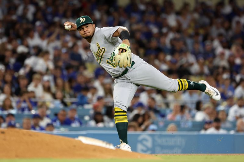 Aug 3, 2023; Los Angeles, California, USA;  Oakland Athletics third baseman Jordan Diaz (13) throws to first during the sixth inning against the Los Angeles Dodgers at Dodger Stadium. Mandatory Credit: Kiyoshi Mio-USA TODAY Sports