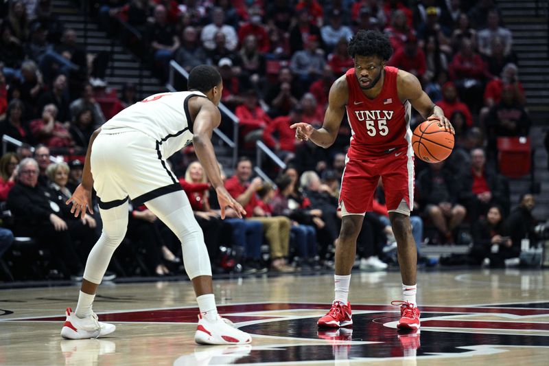 Feb 11, 2023; San Diego, California, USA; UNLV Rebels guard EJ Harkless (55) gestures while dribbling the ball while defended by San Diego State Aztecs guard Micah Parrish (3) during the second half at Viejas Arena. Mandatory Credit: Orlando Ramirez-USA TODAY Sports