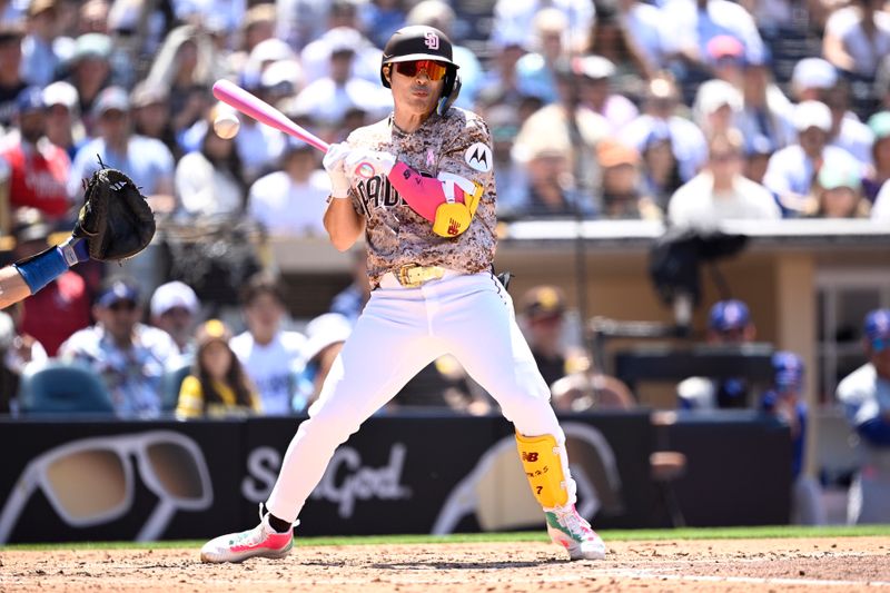 May 12, 2024; San Diego, California, USA; San Diego Padres shortstop Ha-Seong Kim (7) is hit by a pitch during the fourth inning against the Los Angeles Dodgers at Petco Park. Mandatory Credit: Orlando Ramirez-USA TODAY Sports