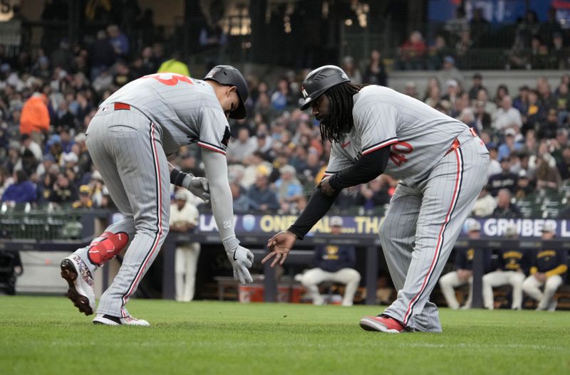 May 18, 2025; Milwaukee, Wisconsin, USA; Minnesota Twins third base coach/outfield coach Tommy Watkins (40) congratulates Minnesota Twins third base Royce Lewis (23) after hitting a home run against the Milwaukee Brewers in the fourth inning at American Family Field. Mandatory Credit: Michael McLoone-Imagn Images