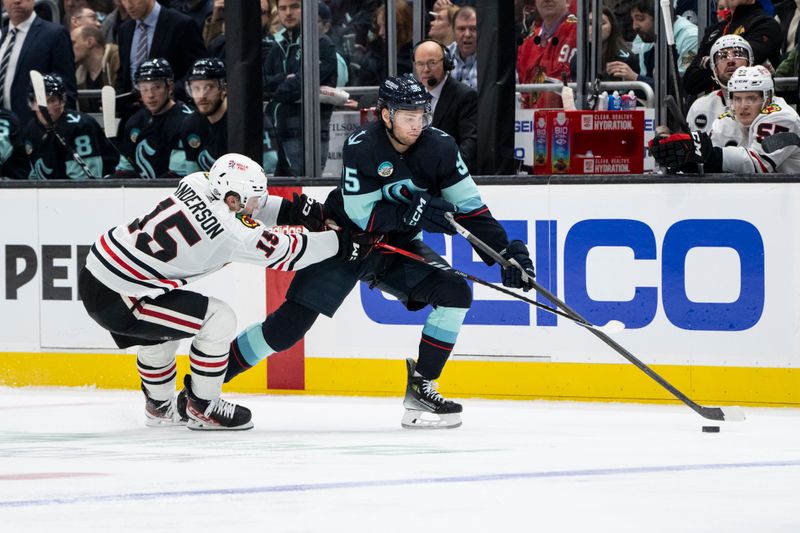 Jan 24, 2024; Seattle, Washington, USA; Seattle Kraken forward Andre Burakovsky (95) skates against Chicago Blackhawks forward Joey Anderson (15) during the second period at Climate Pledge Arena. Mandatory Credit: Stephen Brashear-USA TODAY Sports