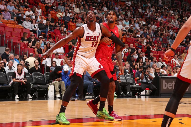 MIAMI, FL - APRIL 12:  Bam Adebayo #13 of the Miami Heat boxes out during the game against the Toronto Raptors on April 12, 2024 at Kaseya Center in Miami, Florida. NOTE TO USER: User expressly acknowledges and agrees that, by downloading and or using this Photograph, user is consenting to the terms and conditions of the Getty Images License Agreement. Mandatory Copyright Notice: Copyright 2024 NBAE (Photo by Issac Baldizon/NBAE via Getty Images)