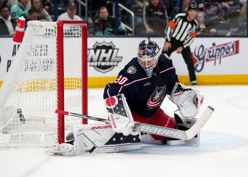 Mar 3, 2023; Columbus, Ohio, USA; Columbus Blue Jackets goaltender Elvis Merzlikins (90) deflects the puck during the first period against the Seattle Kraken at Nationwide Arena. Mandatory Credit: Jason Mowry-USA TODAY Sports