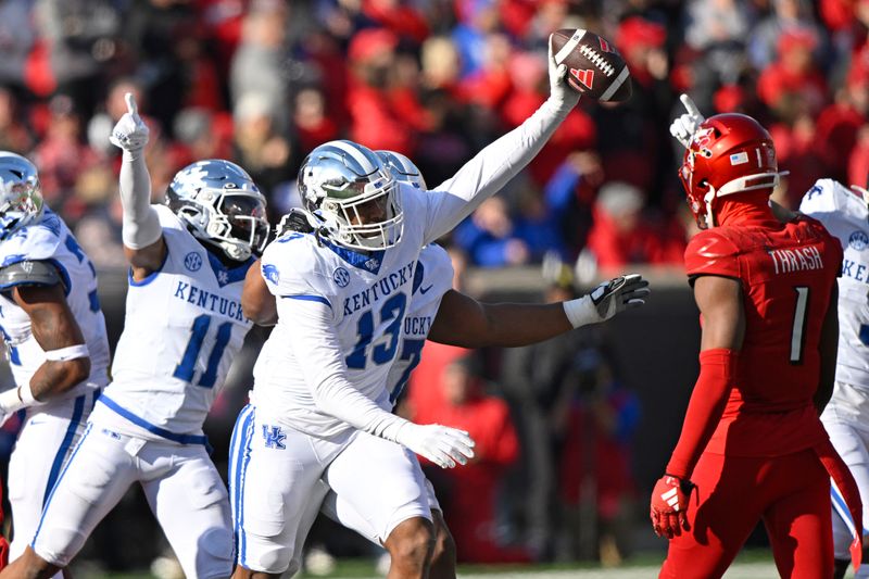 Nov 25, 2023; Louisville, Kentucky, USA;  Kentucky Wildcats linebacker J.J. Weaver (13) celebrates a fumble recovery during the second half against the Louisville Cardinals at L&N Federal Credit Union Stadium. Kentucky defeated Louisville 38-31. Mandatory Credit: Jamie Rhodes-USA TODAY Sports