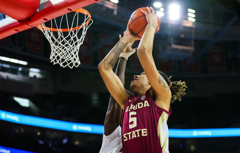 Feb 1, 2023; Raleigh, North Carolina, USA; Florida State Seminoles forward De'Ante Green (5) drives for a dunk during the second half against North Carolina State Wolfpack at PNC Arena.  Mandatory Credit: Jaylynn Nash-USA TODAY Sports