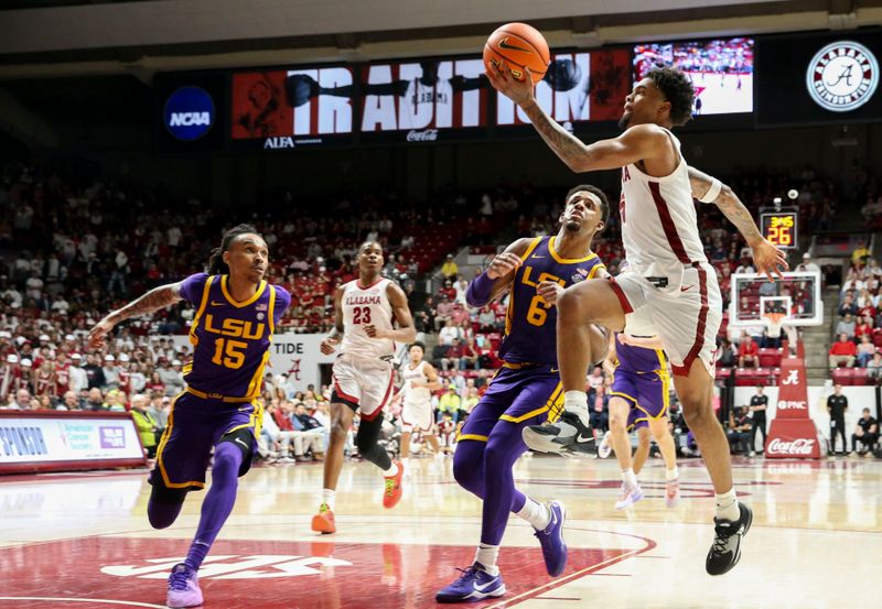 Jan 27, 2024; Tuscaloosa, Alabama, USA;   Alabama guard Aaron Estrada goes for a layup against LSU forward Tyrell Ward (15) and LSU guard Jordan Wright (6) at Coleman Coliseum. Alabama defeated LSU 109-88. Mandatory Credit: Gary Cosby Jr.-USA TODAY Sports