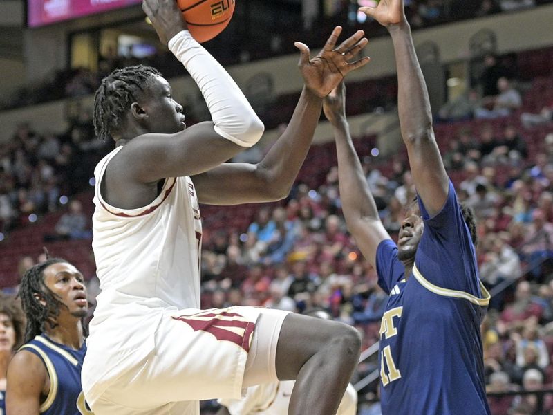 Jan 18, 2025; Tallahassee, Florida, USA; Florida State Seminoles forward Jerry Deng (7) shoots the ball against Georgia Tech Yellowjackets forward Baye Ndongo (11) during the second half at Donald L. Tucker Center. Mandatory Credit: Robert Myers-Imagn Images