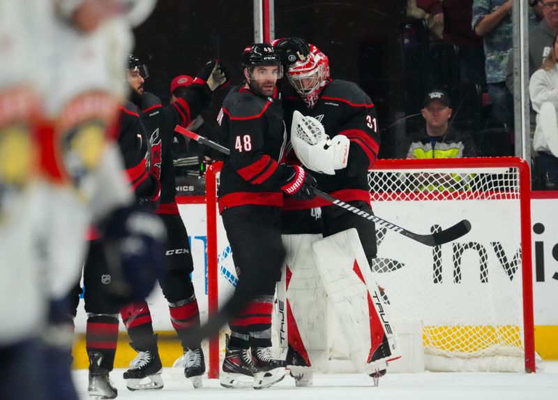 Mar 14, 2024; Raleigh, North Carolina, USA; Carolina Hurricanes goaltender Frederik Andersen (31) and left wing Jordan Martinook (48) celebrate their victory against the Florida Panthers at PNC Arena. Mandatory Credit: James Guillory-USA TODAY Sports