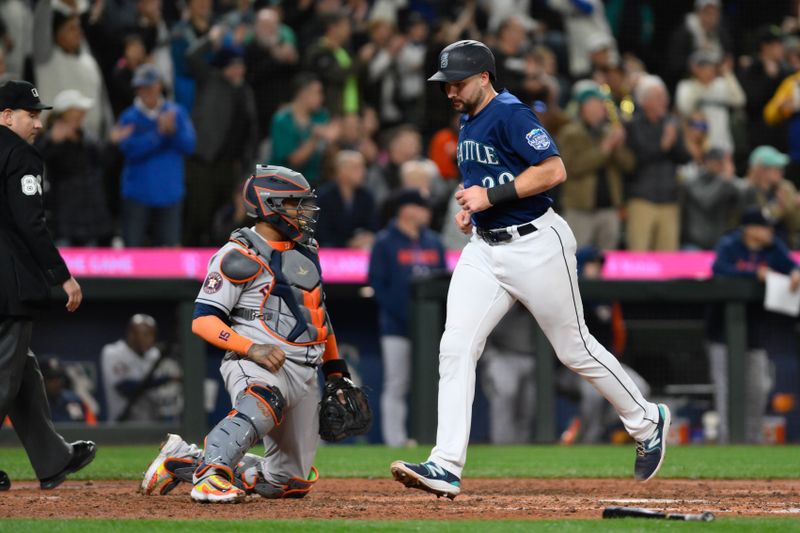 Sep 26, 2023; Seattle, Washington, USA; Seattle Mariners catcher Cal Raleigh (29) scores a run against the Houston Astros during the fifth inning at T-Mobile Park. Mandatory Credit: Steven Bisig-USA TODAY Sports