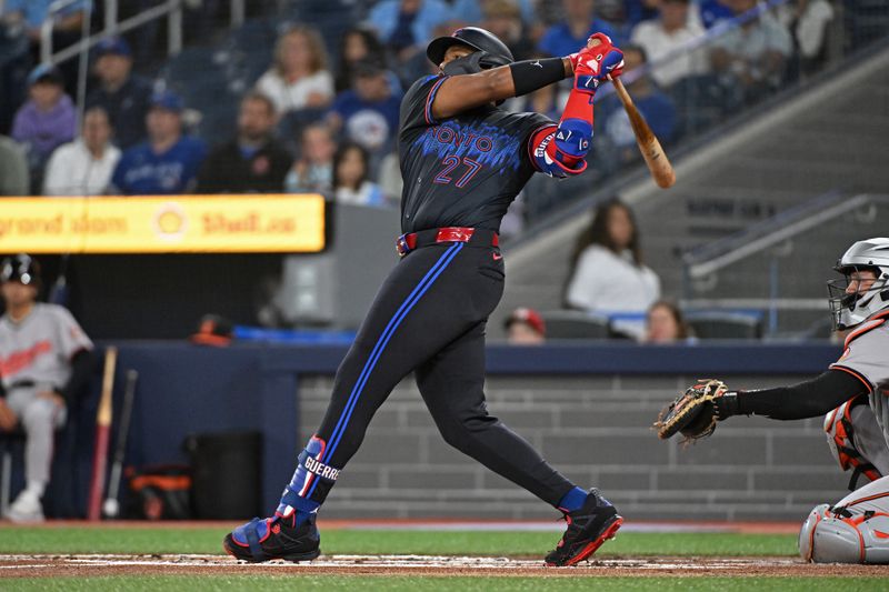 Aug 8, 2024; Toronto, Ontario, CAN; Toronto Blue Jays first base Vladimir Guerrero Jr. (27) hits a RBI double in the second inning against the Baltimore Orioles at Rogers Centre. Mandatory Credit: Gerry Angus-USA TODAY Sports