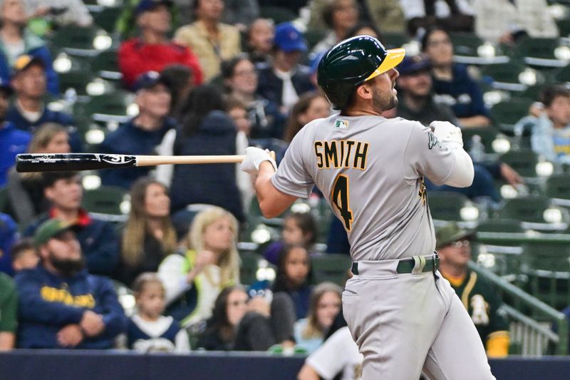 Jun 11, 2023; Milwaukee, Wisconsin, USA; Oakland Athletes shortstop Kevin Smith (4) hits a solo home run against the Milwaukee Brewers in the seventh inning at American Family Field. Mandatory Credit: Benny Sieu-USA TODAY Sports