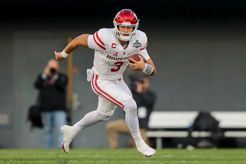 Dec 4, 2021; Cincinnati, Ohio, USA; Houston Cougars quarterback Clayton Tune (3) runs with the ball against the Cincinnati Bearcats in the first half during the American Athletic Conference championship game at Nippert Stadium. Mandatory Credit: Katie Stratman-USA TODAY Sports