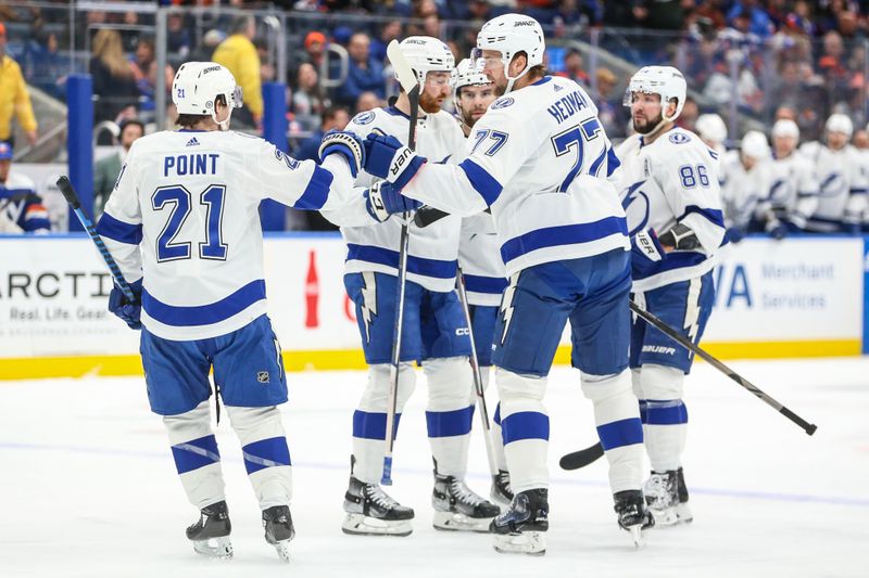 Feb 24, 2024; Elmont, New York, USA;  Tampa Bay Lightning center Brayden Point (21) is greeted by his teammates after scoring a goal in the first period against the New York Islanders at UBS Arena. Mandatory Credit: Wendell Cruz-USA TODAY Sports