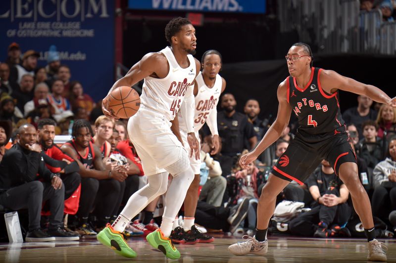 CLEVELAND, OH - NOVEMBER 24: Donovan Mitchell #45 of the Cleveland Cavaliers handles the ball during the game against the Toronto Raptors on November 24, 2024 at Rocket Mortgage FieldHouse in Cleveland, Ohio. NOTE TO USER: User expressly acknowledges and agrees that, by downloading and/or using this Photograph, user is consenting to the terms and conditions of the Getty Images License Agreement. Mandatory Copyright Notice: Copyright 2024 NBAE (Photo by David Liam Kyle/NBAE via Getty Images)