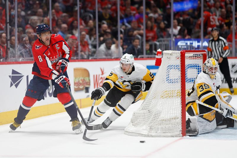 Apr 4, 2024; Washington, District of Columbia, USA; Washington Capitals left wing Alex Ovechkin (8) passes the puck behind Pittsburgh Penguins goaltender Alex Nedeljkovic (39) as Penguins defenseman Ryan Shea (5) defends in the first period at Capital One Arena. Mandatory Credit: Geoff Burke-USA TODAY Sports