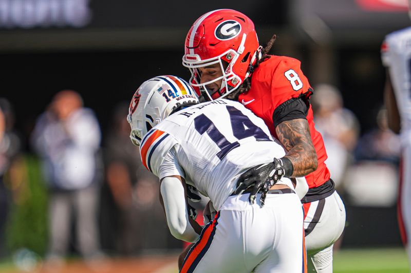 Oct 5, 2024; Athens, Georgia, USA; Georgia Bulldogs defensive back Joenel Aguero (8) tackles Auburn Tigers wide receiver Robert Lewis (14) during the first half at Sanford Stadium. Mandatory Credit: Dale Zanine-Imagn Images