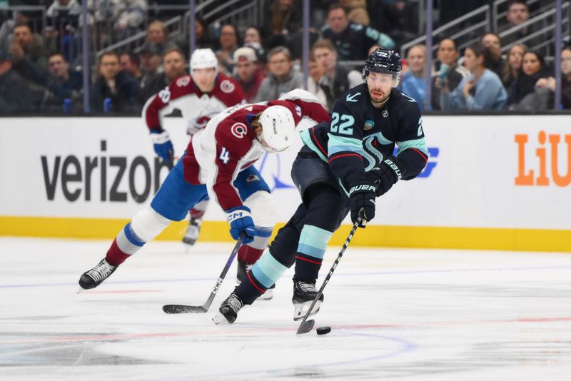 Nov 13, 2023; Seattle, Washington, USA; Seattle Kraken right wing Oliver Bjorkstrand (22) advances the puck while Colorado Avalanche defenseman Bowen Byram (4) chases during the second period at Climate Pledge Arena. Mandatory Credit: Steven Bisig-USA TODAY Sports